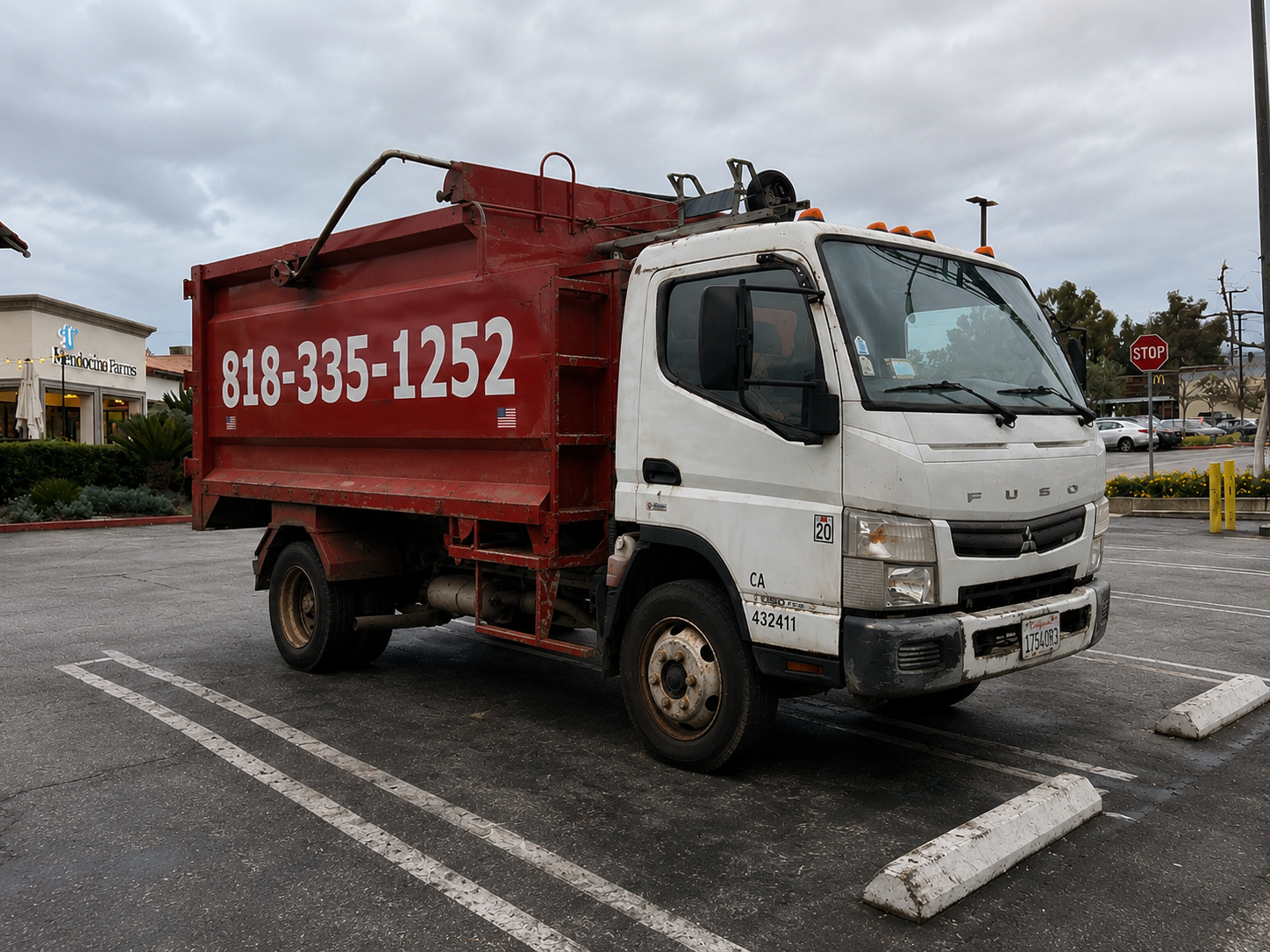 Small Time Hauling red dump truck with phone number 818-335-1252 ready for junk removal in the San Fernando Valley