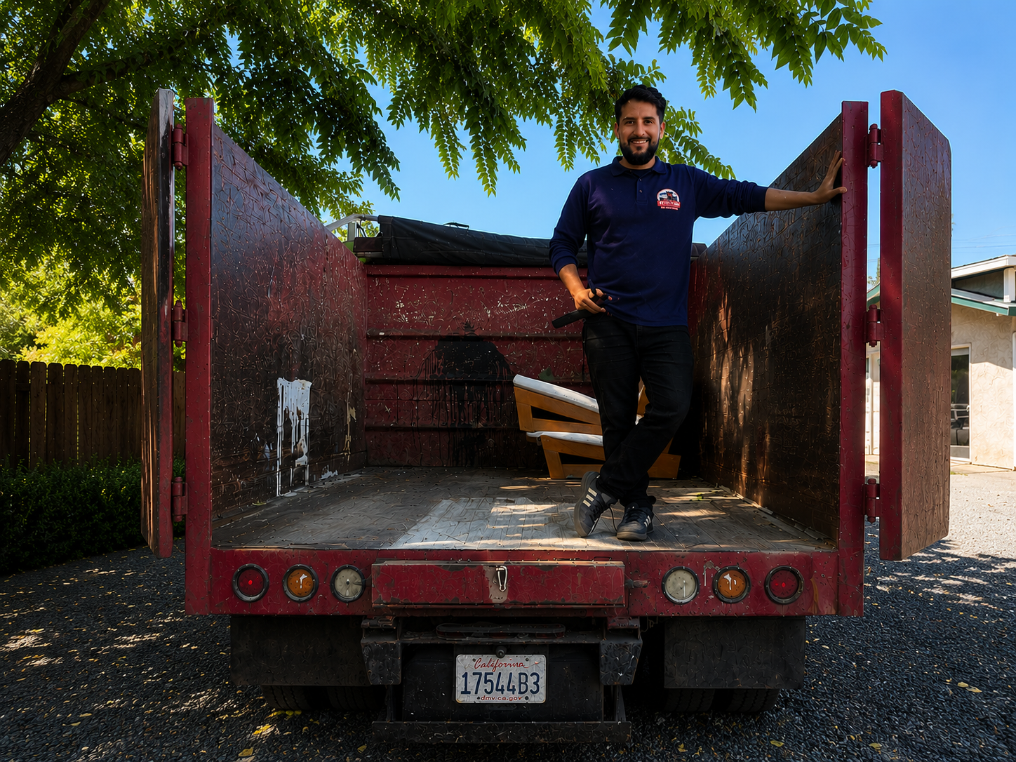 Small Time Hauling owner at the rear of the open dump truck ready to load